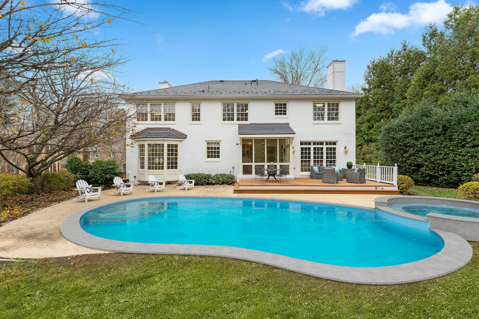 Backyard pool with a light concrete deck
